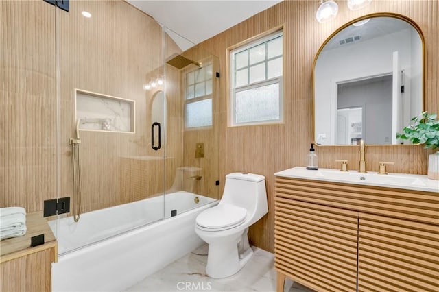 full bathroom with vanity, toilet, and bath / shower combo with glass door