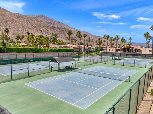 view of tennis court with a mountain view