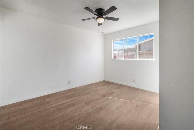 spare room with hardwood / wood-style flooring and ceiling fan