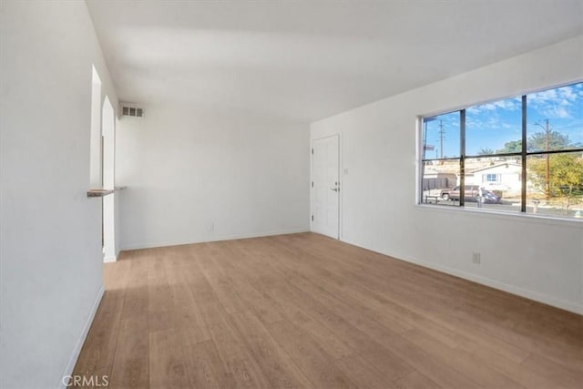 spare room with light hardwood / wood-style flooring