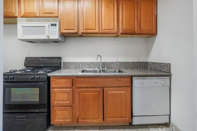 kitchen with light tile patterned floors, white appliances, and sink