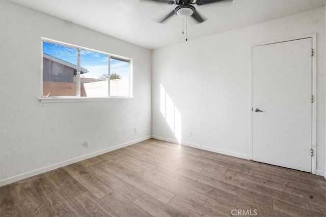 empty room featuring ceiling fan and wood-type flooring