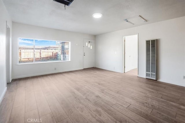 spare room with light hardwood / wood-style flooring