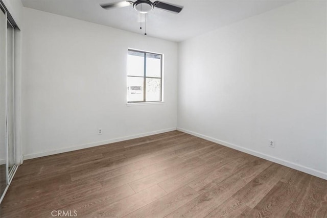 spare room featuring ceiling fan and wood-type flooring