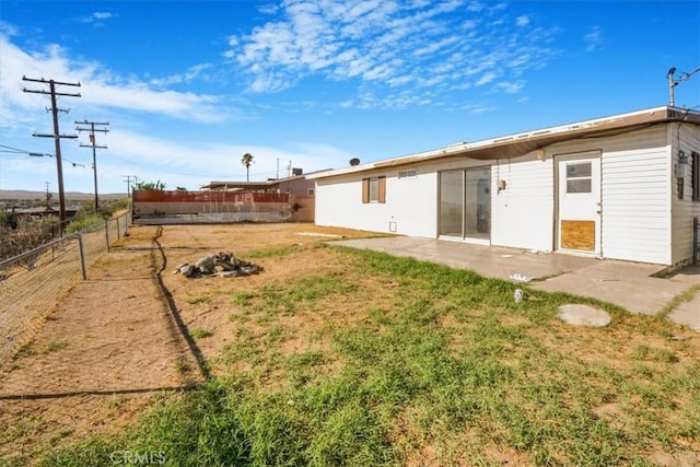 rear view of property with a patio area and a yard