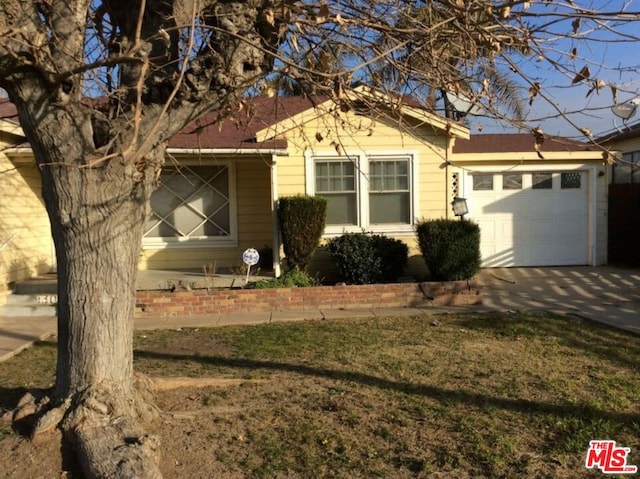 single story home with a garage and a front yard