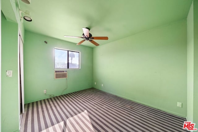 unfurnished room featuring carpet floors, an AC wall unit, and ceiling fan