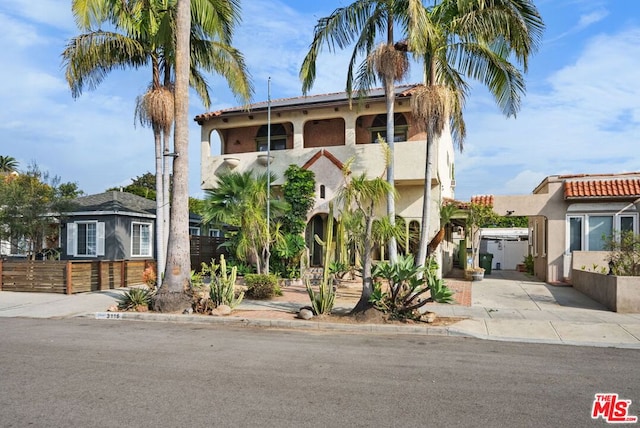 mediterranean / spanish-style home featuring a balcony