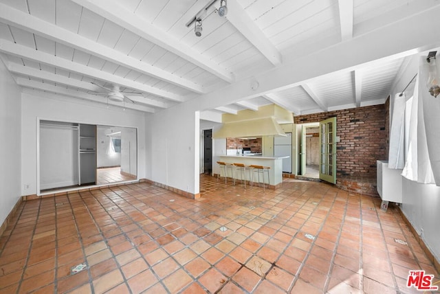 unfurnished living room with tile patterned flooring, ceiling fan, beam ceiling, and wooden ceiling