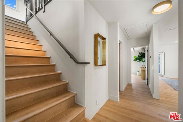 stairs featuring hardwood / wood-style flooring