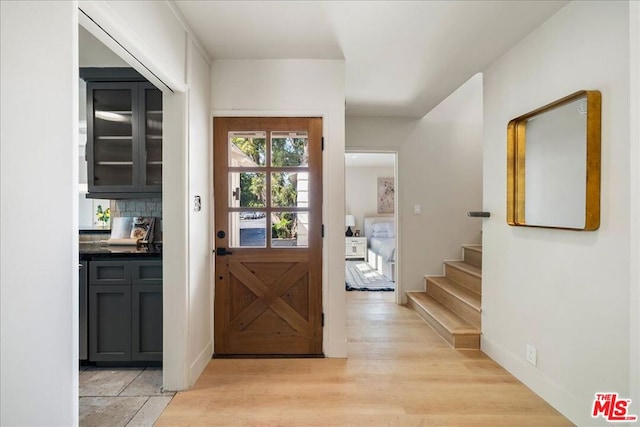 doorway with light hardwood / wood-style flooring