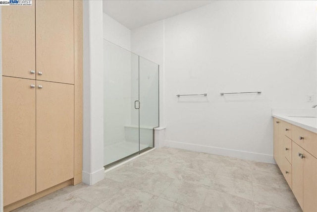 bathroom featuring walk in shower and vanity