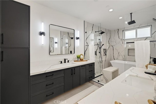 bathroom featuring a tile shower and vanity