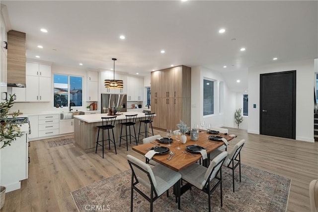 dining area featuring sink and light hardwood / wood-style floors