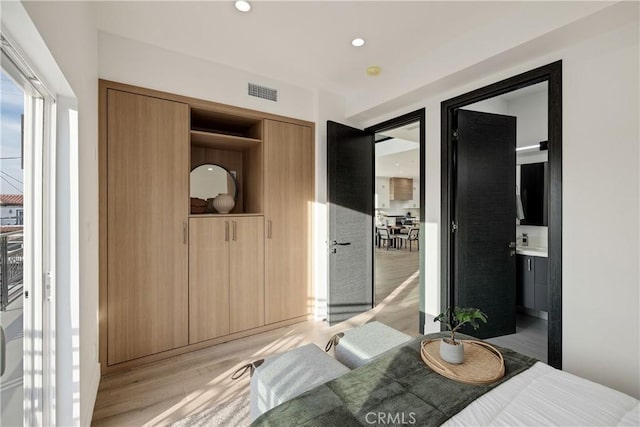 bedroom featuring a closet and light hardwood / wood-style floors