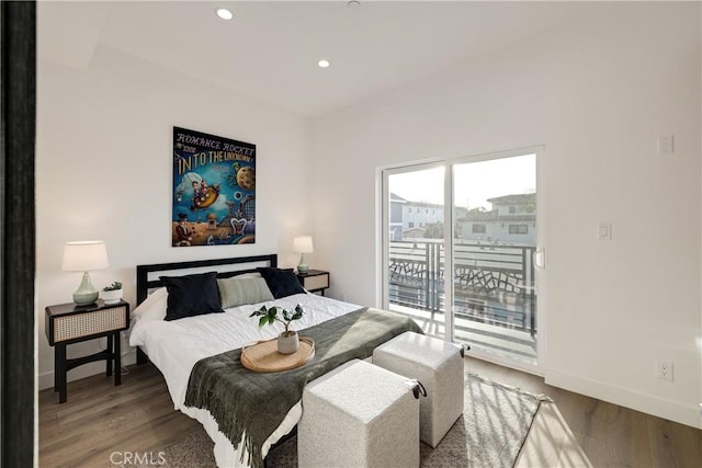 bedroom featuring dark wood-type flooring and access to outside