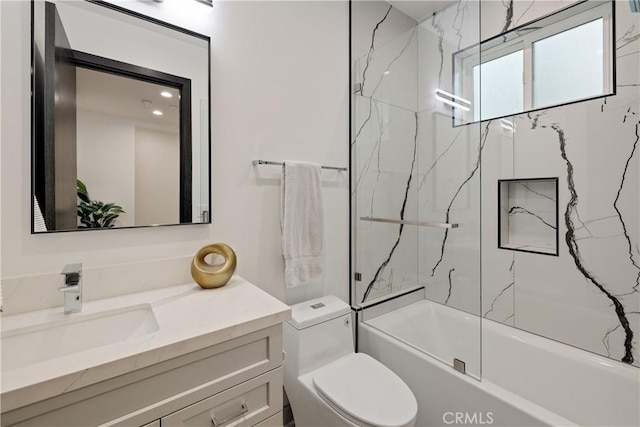 full bathroom with toilet, vanity, and tiled shower / bath