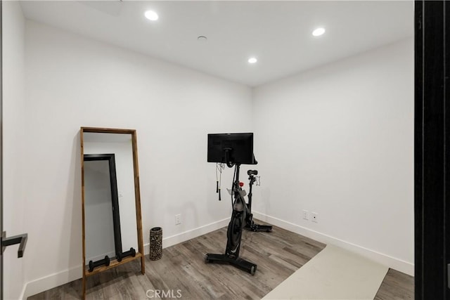 exercise room with hardwood / wood-style flooring