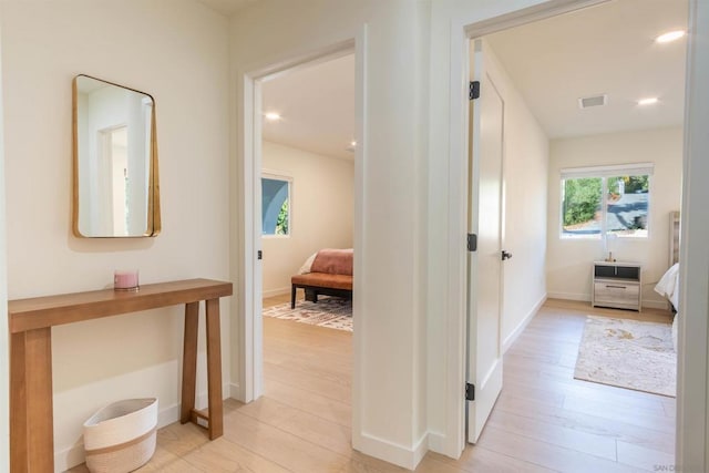 hall with light hardwood / wood-style floors