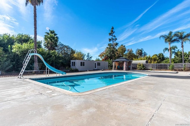 view of pool with a gazebo, a patio area, and a water slide