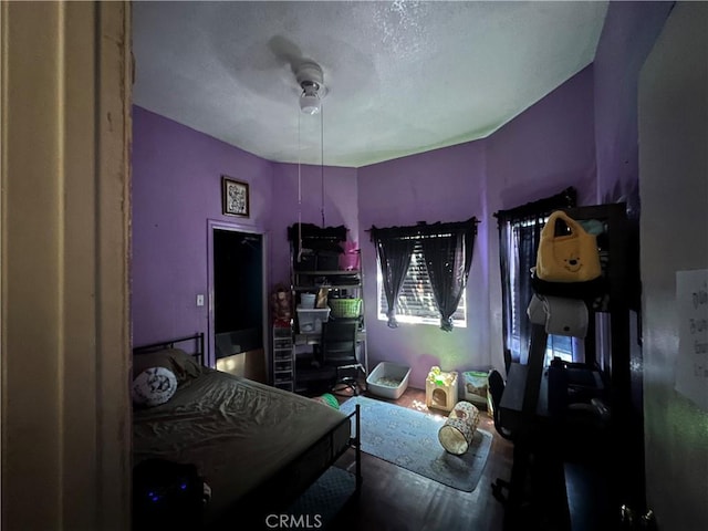 bedroom with a textured ceiling and ceiling fan