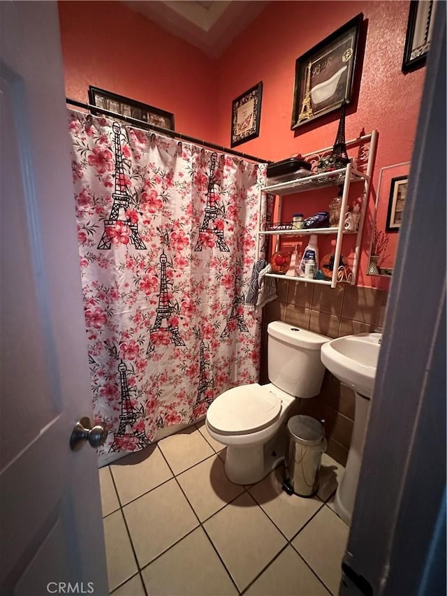 bathroom featuring tile patterned flooring and toilet