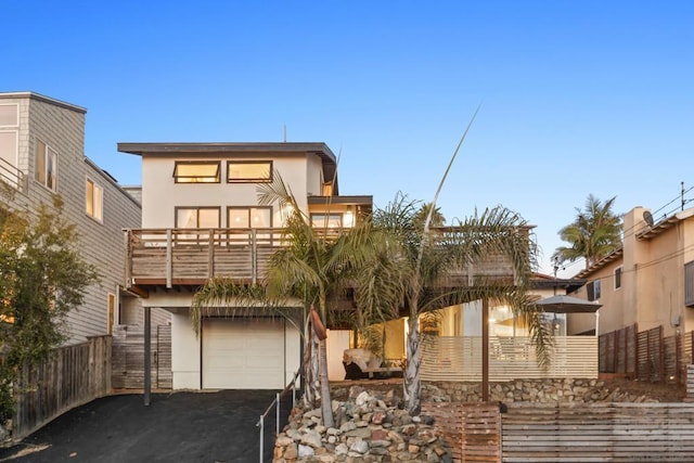 view of front of property with a garage and a balcony