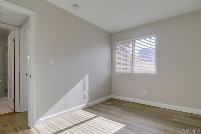 spare room with light hardwood / wood-style floors