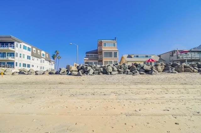 view of yard with a beach view