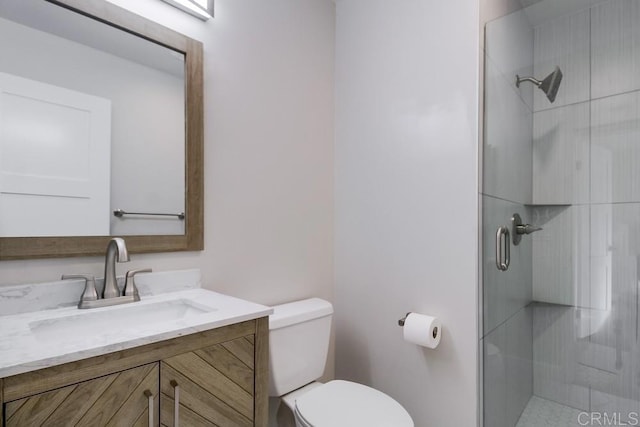 bathroom with vanity, toilet, and an enclosed shower