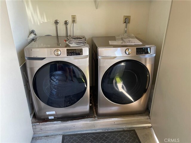 clothes washing area featuring washing machine and dryer