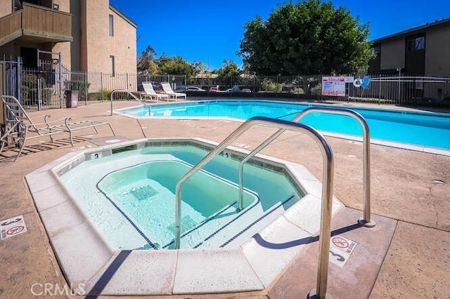 view of pool featuring a patio area and a community hot tub