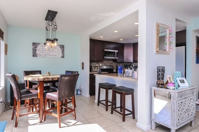 dining area featuring light tile patterned flooring