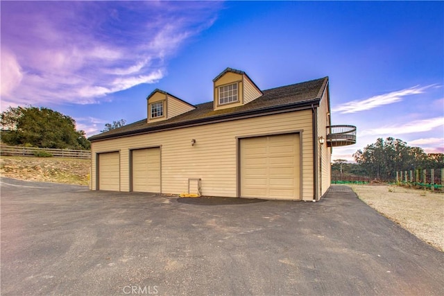 view of garage at dusk