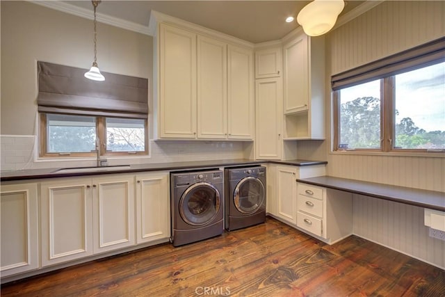 laundry area with plenty of natural light, cabinets, dark wood-type flooring, and washing machine and dryer