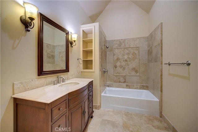 bathroom featuring vanity, tile patterned floors, tiled shower / bath combo, and vaulted ceiling