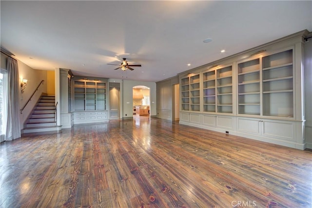 unfurnished living room with hardwood / wood-style floors, built in features, and ceiling fan