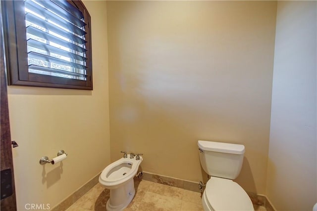 bathroom with toilet and a bidet