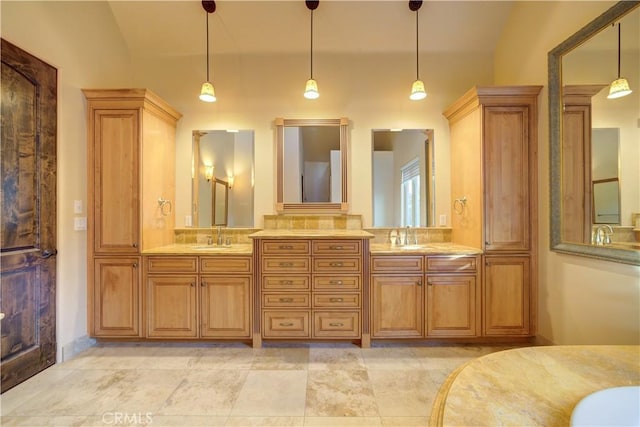 bathroom with vanity and lofted ceiling