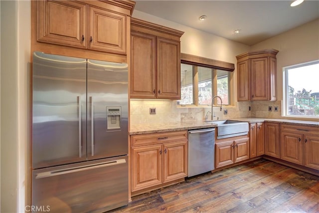 kitchen featuring plenty of natural light, dark hardwood / wood-style flooring, sink, and appliances with stainless steel finishes