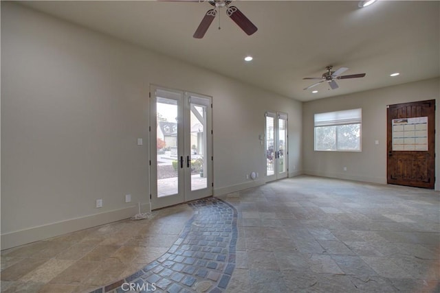 spare room with ceiling fan and french doors