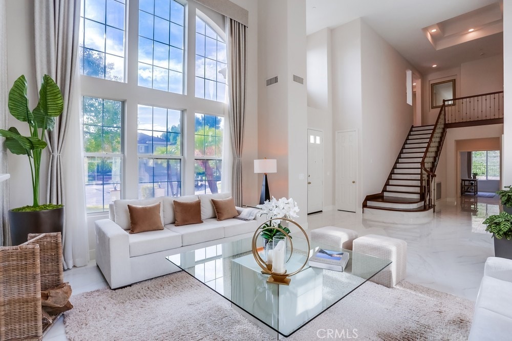 living room with a wealth of natural light and a high ceiling