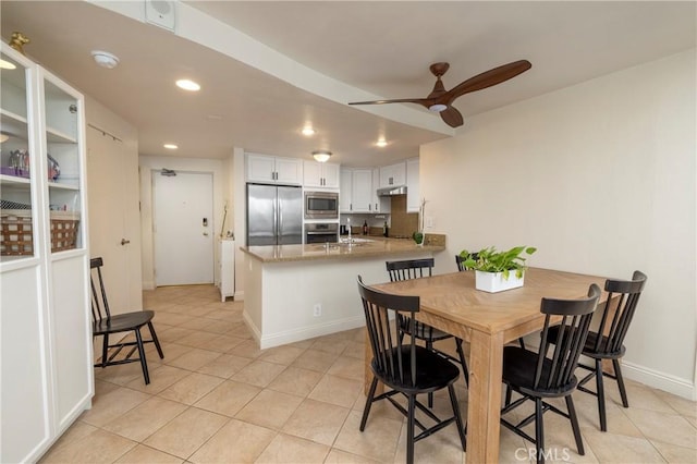 dining space featuring ceiling fan and light tile patterned floors