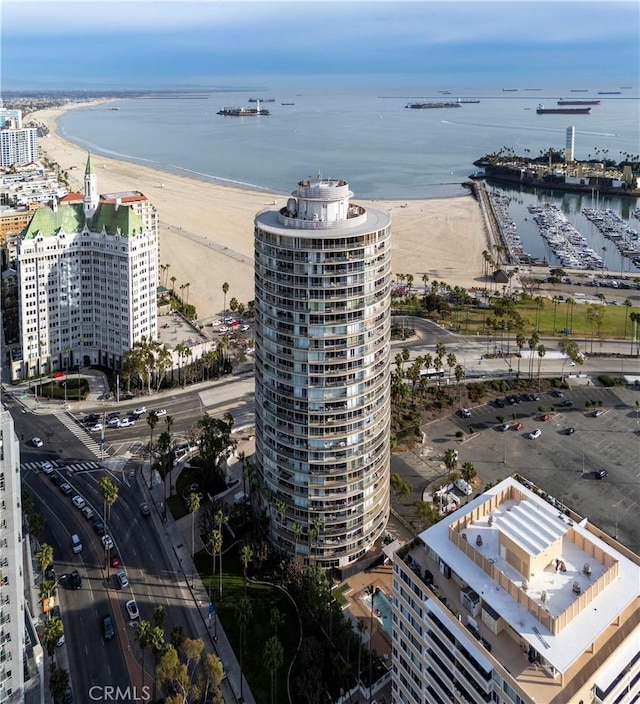 bird's eye view featuring a view of the beach and a water view