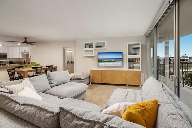 living room featuring ceiling fan and light tile patterned floors