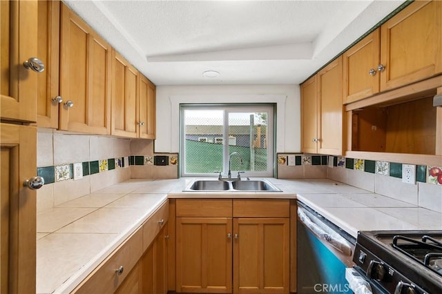 kitchen with tile counters, sink, black electric range, stainless steel dishwasher, and backsplash