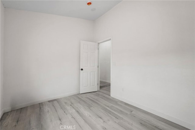 empty room with light hardwood / wood-style flooring