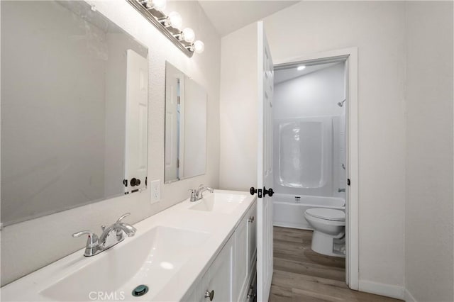 full bathroom with toilet, wood-type flooring, vanity, and bathing tub / shower combination