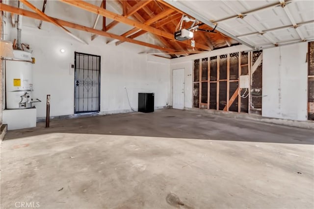 garage featuring a garage door opener and water heater