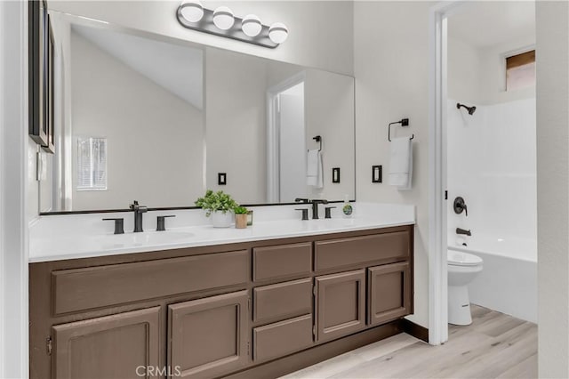 full bathroom featuring hardwood / wood-style flooring,  shower combination, toilet, and vanity